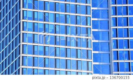Exterior view of corporate headquarters glass buildings architecture. Modern sustainable glass office buildings. Glass windows in energy-efficient buildings. Financial business center buildings. Exterior view of corporate headquarters glass buildings architecture. Modern sustainable glass office buildings. Glass windows in energy-efficient buildings. Financial business center buildings. 136700155