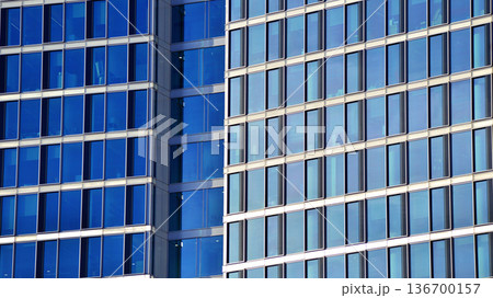 Exterior view of corporate headquarters glass buildings architecture. Modern sustainable glass office buildings. Glass windows in energy-efficient buildings. Financial business center buildings. Exterior view of corporate headquarters glass buildings architecture. Modern sustainable glass office buildings. Glass windows in energy-efficient buildings. Financial business center buildings. 136700157