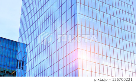 Exterior view of corporate headquarters glass buildings architecture. Modern sustainable glass office buildings. Glass windows in energy-efficient buildings. Financial business center buildings.  136700221