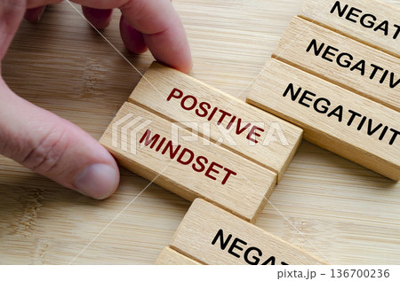 Negativity and Positivity text on wooden blocks representing replacing negativity with a positive growth mindset Negativity and Positivity text on wooden blocks representing replacing negativity with a positive growth mindset 136700236