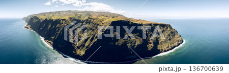 Drone panorama from the sea shows Ponta do Pargo, Madeira, vast Atlantic around sheer green cliffs 136700639