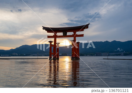 Famous red torii gate of Itsukushima shrine at sunset in Miyajima, Japan Famous red torii gate of Itsukushima shrine at sunset in Miyajima, Japan 136701121