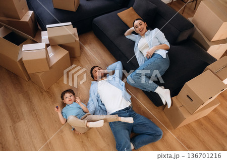 Top view, lying down on floor. Family of husband, wife and son are moving into new house 136701216