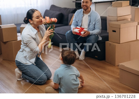 Gifts and flowers for mother. Family of husband, wife and son are moving into new house Gifts and flowers for mother. Family of husband, wife and son are moving into new house 136701228