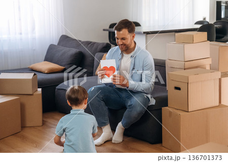 Father with son are in new home, with gifts Father with son are in new home, with gifts 136701373