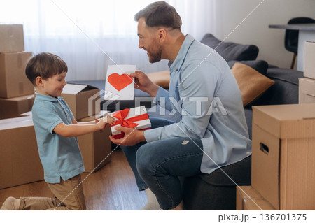 Father with son are in new home, with gifts 136701375
