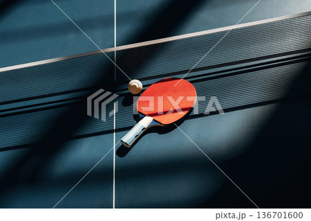 Racket and ball are on the tennis table indoors 136701600