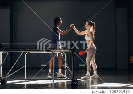 Just standing. Tennis game, man and woman are indoors Just standing. Tennis game, man and woman are indoors 136701950