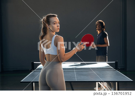 Tennis game, man and woman are indoors Tennis game, man and woman are indoors 136701952