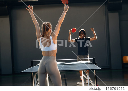 Competition conception. Tennis game, man and woman are indoors Competition conception. Tennis game, man and woman are indoors 136701961