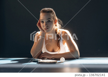 Beautiful young woman is by the tennis table indoors Beautiful young woman is by the tennis table indoors 136702141