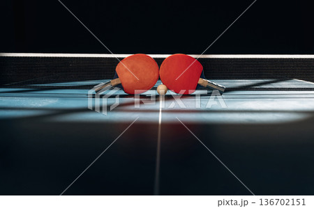Horizontal photo. Two rackets and ball on the tennis table 136702151