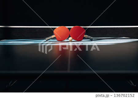 Horizontal photo. Two rackets and ball on the tennis table 136702152
