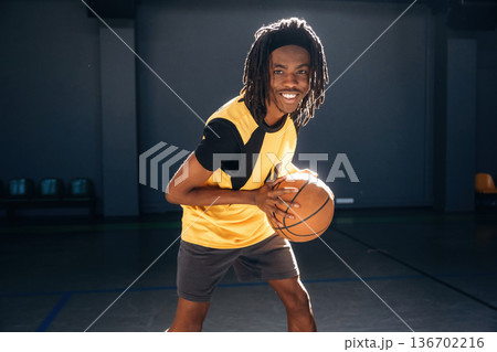 One person only. Young black man is playing basketball indoors 136702216