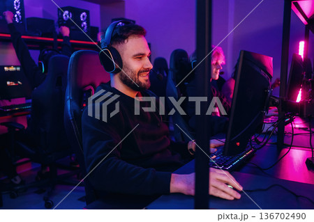 Using keyboard and mouse. Gamers are playing video game by computers Using keyboard and mouse. Gamers are playing video game by computers 136702490