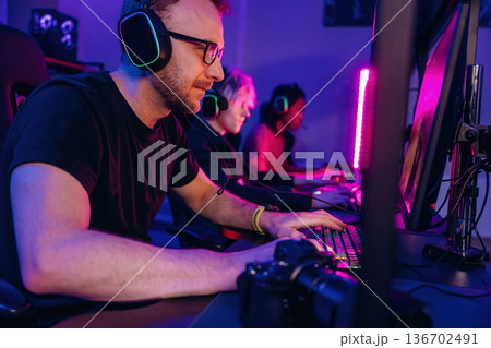 Session of online tournament. Gamers are playing video game by computers Session of online tournament. Gamers are playing video game by computers 136702491