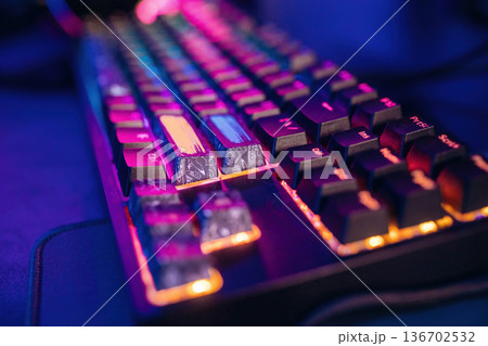 Colorful keyboard. Gaming computer is in the dark room with neon lighting 136702532