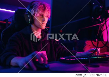 Session of online tournament. Gamers are playing video game by computers Session of online tournament. Gamers are playing video game by computers 136702584