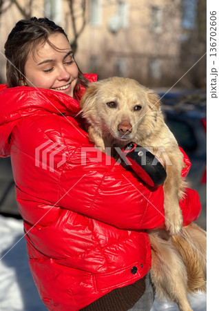 Animal shelter volunteer takes care of dog. Dog at the shelter. Animal shelter volunteer takes care of dog. Dog at the shelter. 136702606