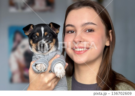 Animal shelter volunteer takes care of dog. Dog at the shelter. 136702609