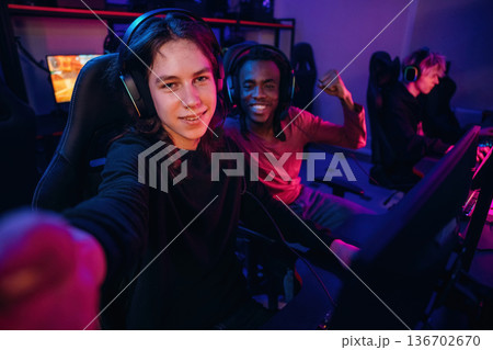 Selfie time. Gamers are playing video game by computers 136702670