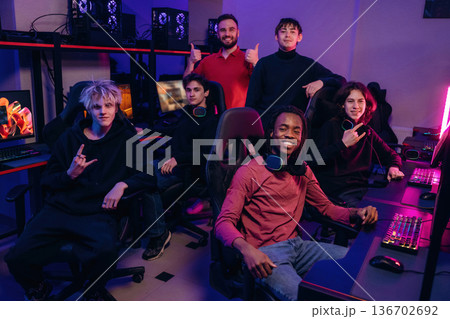 Team of gamers are chilling together indoors Team of gamers are chilling together indoors 136702692