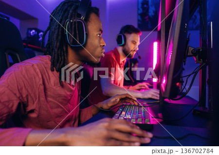 High end PC's, side view. Gamers are playing video game by computers 136702784