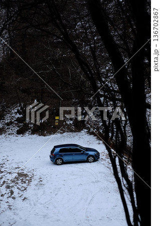 雪の中に停まる青い車 136702867
