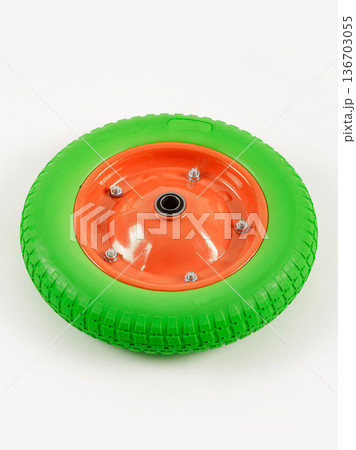 Wheel is pneumatic on a white background. Green rubber, orange disc. 136703055