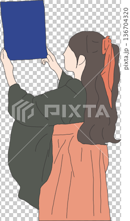 A woman in a hakama holding up her diploma A woman in a hakama holding up her diploma 136704320