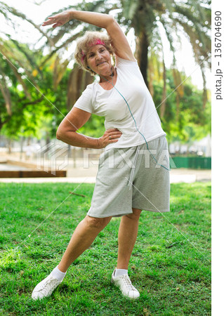 Mature woman training in park Mature woman training in park 136704690