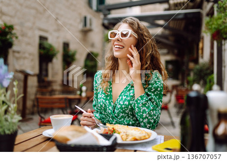 Young Woman eating Italian pasta at restaurant on the street in Rome. Gastronomy and travel Young Woman eating Italian pasta at restaurant on the street in Rome. Gastronomy and travel 136707057