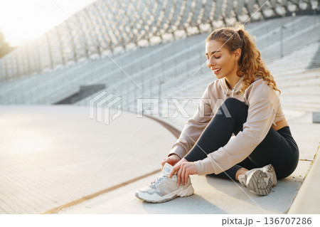 Beautiful woman outdoors and sportswear doing fitness. Concept of sport, recreation. Beautiful woman outdoors and sportswear doing fitness. Concept of sport, recreation. 136707286