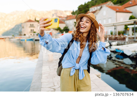 Beautiful female tourist walks streets and photographed attractions. Travel, rest, weekend, life. Beautiful female tourist walks streets and photographed attractions. Travel, rest, weekend, life. 136707634