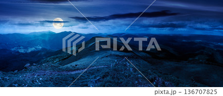 beautiful landscape of mountainous area on a summer night. panoramic view of great ridge in dappled full moon light. alpine scenery with path through green grass on steep slopes. cloudy weather beautiful landscape of mountainous area on a summer night. panoramic view of great ridge in dappled full moon light. alpine scenery with path through green grass on steep slopes. cloudy weather 136707825