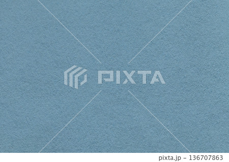 Dusty blue textured paper background with subtle grain surface and soft structure. Cold backdrop, macro 136707863