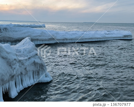 Snow- and ice-covered breakwaters in the Baltic Sea in winter Snow- and ice-covered breakwaters in the Baltic Sea in winter 136707977