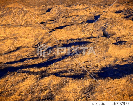 Snowdrifts illuminated by warm orange light, beautiful winter landscape Snowdrifts illuminated by warm orange light, beautiful winter landscape 136707978