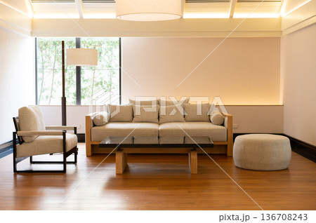 Minimalist modern living room interior with cozy sofa and warm lighting 136708243