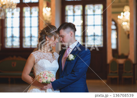 Elegant Wedding Couple Holding Bouquet In Ceremony Hall Elegant Wedding Couple Holding Bouquet In Ceremony Hall 136708539