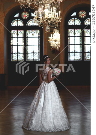 Bride Looking Back In Ornate Wedding Hall Bride Looking Back In Ornate Wedding Hall 136708547