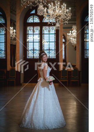 Timeless Bride Holding Bouquet In Historic Hall Timeless Bride Holding Bouquet In Historic Hall 136708549