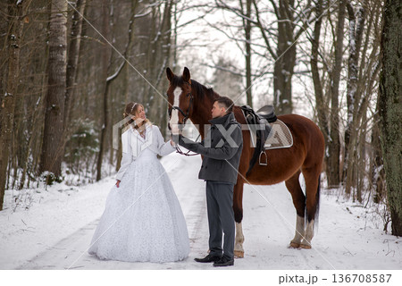 Elegant Winter Bride Standing Beside Horse Outdoors 136708587