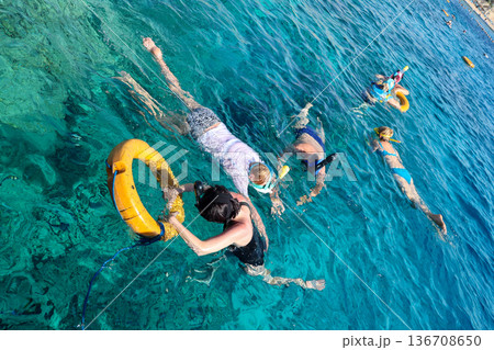 Egypt, Sharm el-Sheikh - September 28, 2025. A group of tourists look at the underwater world of the Red Sea. Editorial 136708650