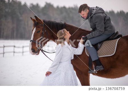 Joyful Bride Standing Beside Horse Looking At Groom 136708759