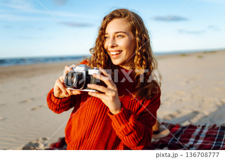 Happy woman with retro camera on the beach. Travel, weekend, relax and lifestyle concept. 136708777