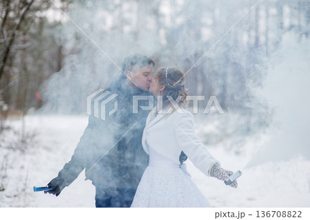 Romantic Winter Kiss With Smoke Flares In Forest Romantic Winter Kiss With Smoke Flares In Forest 136708822