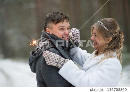 Playful Winter Wedding Moment With Sparklers 136708860