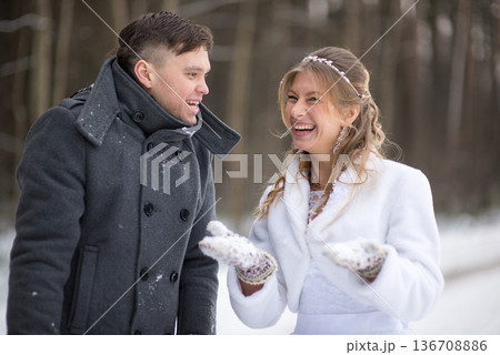 Playful Snow Blowing During Winter Wedding Walk Playful Snow Blowing During Winter Wedding Walk 136708886