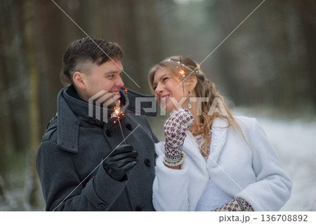 Romantic Winter Wedding Kiss With Glowing Sparklers 136708892